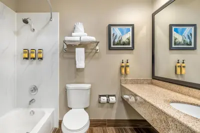a bathroom with a toilet and a sink and a tub at Best Western Plus Sonora Oaks Hotel and Conference Center in Sonora
