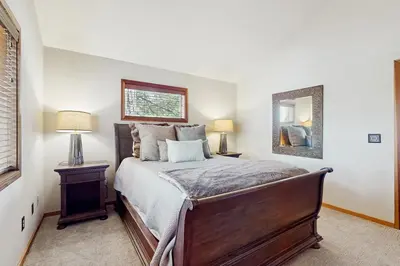 a bedroom with a large bed and a mirror at Sophisticated Northstar Mountain Retreat in Truckee