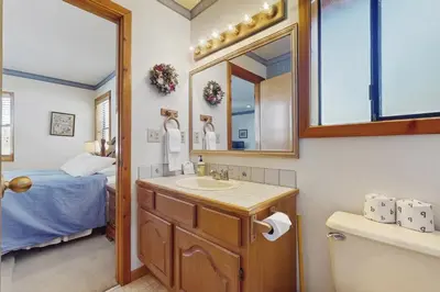 a bathroom with a sink and a mirror and a bed at Tuna Bush in Truckee
