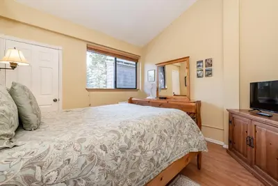 a bedroom with a bed and a flat screen tv at Summit B- # 257 in Mammoth Lakes