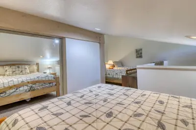 a bedroom with two beds and a window at The Summit 276 in Mammoth Lakes