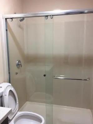 a shower stall in a bathroom with a toilet at La Plaza Inn in Los Banos