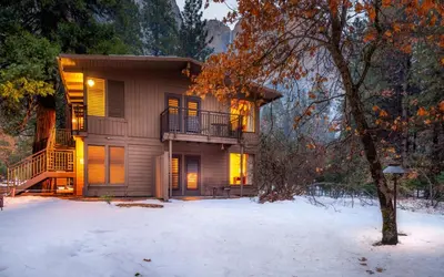 a house with a balcony in the snow at Yosemite Valley Lodge in Yosemite Village