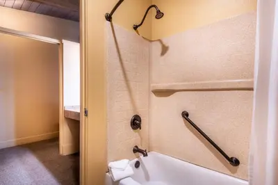 a bathroom with a bath tub and a toilet at Yosemite Valley Lodge in Yosemite Village