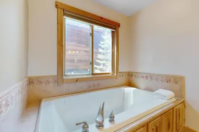 a bath tub in a bathroom with a window at Sweet Cherry Hills Escape in South Lake Tahoe