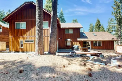 a large wooden house with trees in front of it at Sweet Cherry Hills Escape in South Lake Tahoe