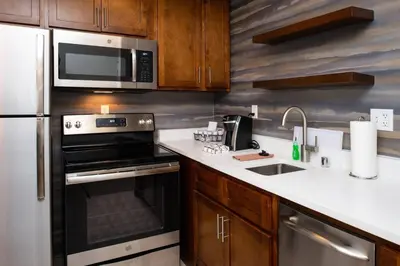 a kitchen with a microwave and a stove and a sink at Residence Inn Visalia in Visalia