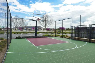 a tennis court with a basketball hoop at Residence Inn Visalia in Visalia