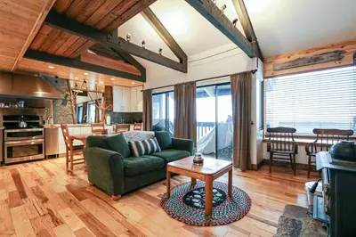 a living room with a green couch and a table at Bigwood #80 condo in Mammoth Lakes