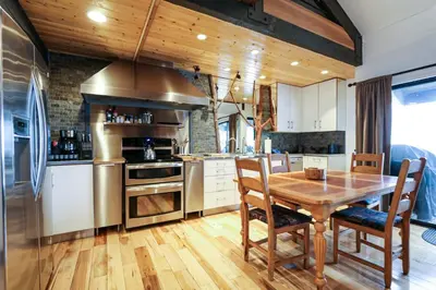 a kitchen with a wooden table and a wooden floor at Bigwood #80 condo in Mammoth Lakes