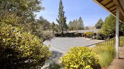 a parking lot in front of a building at Mariposa Lodge in Mariposa