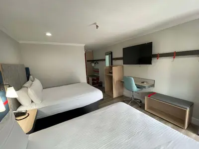 a hotel room with a bed and a tv at The Midtowner Hotel, SureStay Collection by Best Western in Sacramento