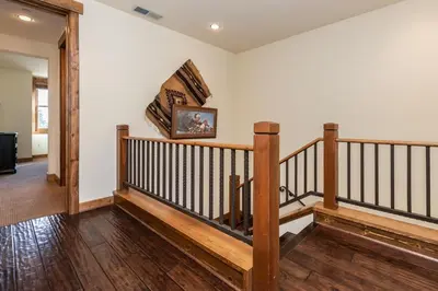 a staircase in a home with wooden railings at Creekhouse 1312 in Mammoth Lakes