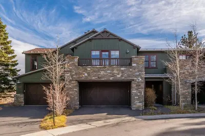 a large green house with a garage at Creekhouse 1312 in Mammoth Lakes