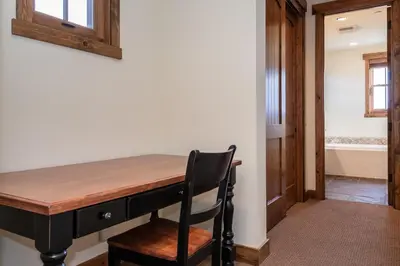 a wooden desk with a chair in a room at Creekhouse 1312 in Mammoth Lakes