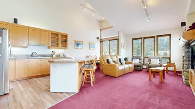 a kitchen and living room with a couch and a table at Snowcreek V #999 condo in Mammoth Lakes