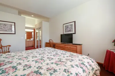 a bedroom with a bed and a flat screen tv at Snowcreek V #999 condo in Mammoth Lakes