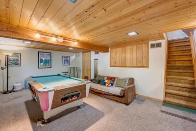 a room with a pool table and a couch at Relaxation on Muletail in Carnelian Bay