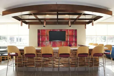 a conference room with chairs and a flat screen tv at La Quinta by Wyndham Madera in Madera
