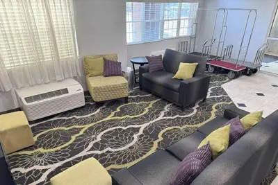 a living room with a couch and two chairs at La Quinta by Wyndham Tulare in Tulare