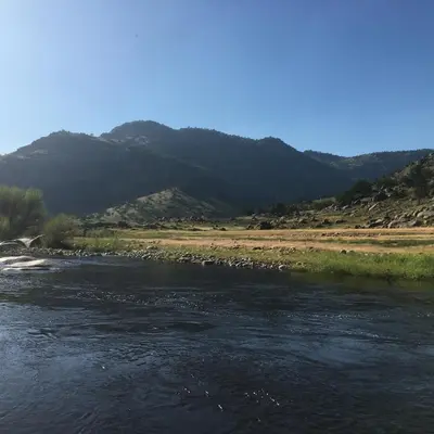 a river with a mountain in the background at Western Holiday Lodge in Three Rivers