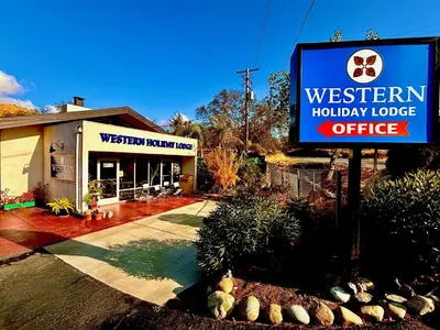 a sign in front of a holiday lodge office at Western Holiday Lodge in Three Rivers