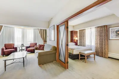 a hotel room with a bed and a couch at Harrah's Lake Tahoe, A Caesars Destination in Stateline