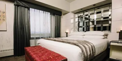 a bedroom with a large white bed and a window at Harrah's Lake Tahoe, A Caesars Destination in Stateline