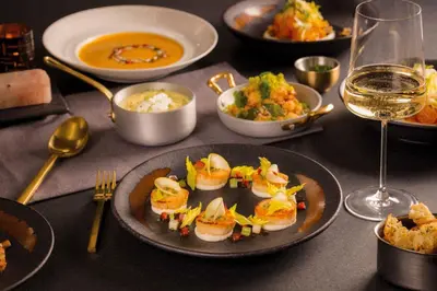 a table with a plate of food and a glass of wine at Caesars Republic Lake Tahoe, A Caesars Destination in Stateline