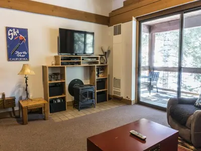 a living room with a couch and a tv at Studio Apartment in Truckee