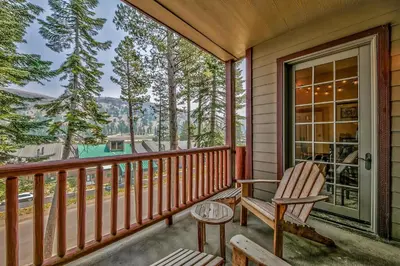 a porch with a rocking chair and a table at Three-Bedroom Townhouse in Kirkwood