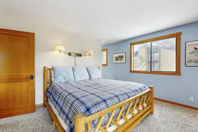 a bedroom with a bed with blue walls and a window at Scott Peak Views in Alpine Meadows