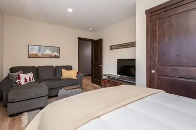 a bedroom with a bed and a couch at Mountainside 15 in Mammoth Lakes