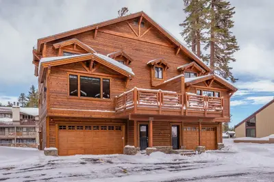 a wooden house with a balcony on top of it at Mountainside 15 in Mammoth Lakes