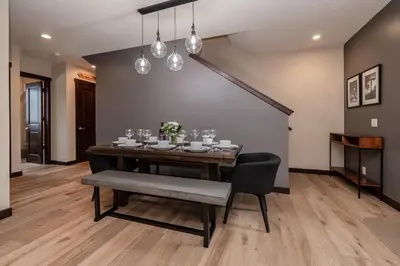 a dining room with a table and a chair at Mountainside 15 in Mammoth Lakes