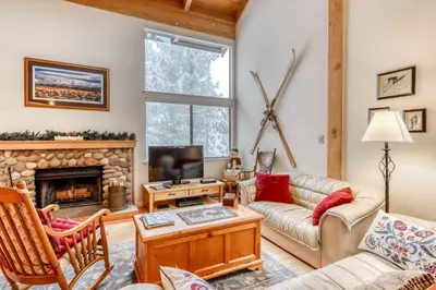 a living room with a couch and a fireplace at Northstar Condo in the Trees in Truckee