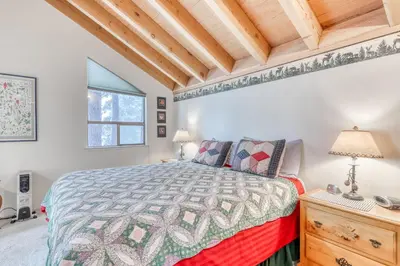 a bedroom with a bed and a wooden ceiling at Northstar Condo in the Trees in Truckee