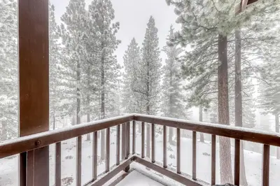 a balcony of a cabin with snow covered trees at Northstar Condo in the Trees in Truckee