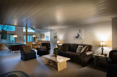 a living room with a couch and chairs and a table at 43 The Last Resort in Wawona