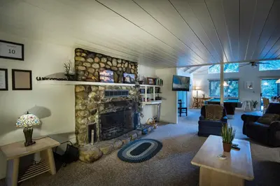 a living room with a fireplace and a couch at 43 The Last Resort in Wawona