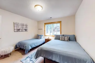 a bedroom with two beds and a window at Trout Creek Condo in Truckee