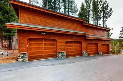a wooden building with two garage doors on it at Trout Creek Condo in Truckee