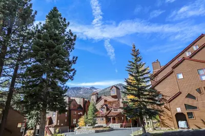 a town with trees and mountains in the background at Aspen Creek #311 condo in Mammoth Lakes