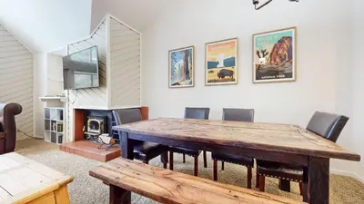 a dining room with a wooden table and chairs at Aspen Creek #311 condo in Mammoth Lakes