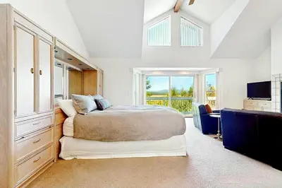 a bedroom with a large bed and a television at Sleek Hill Haven with Martis Valley Views in Polaris