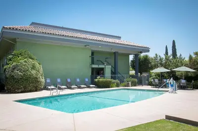 a swimming pool in front of a building at Best Western Village Inn in Fresno