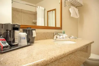 a bathroom with a sink with a coffee maker on it at Best Western Village Inn in Fresno