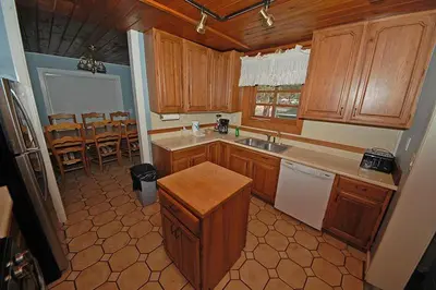 a kitchen with wooden cabinets and a table in it at 3664 Birch Avenue cabin in South Lake Tahoe
