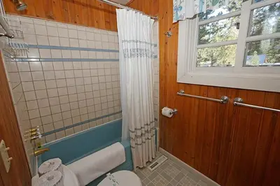 a bathroom with a toilet and a window at 3664 Birch Avenue cabin in South Lake Tahoe