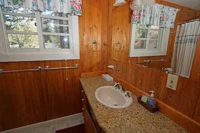 a bathroom with a sink and a mirror at 3664 Birch Avenue cabin in South Lake Tahoe